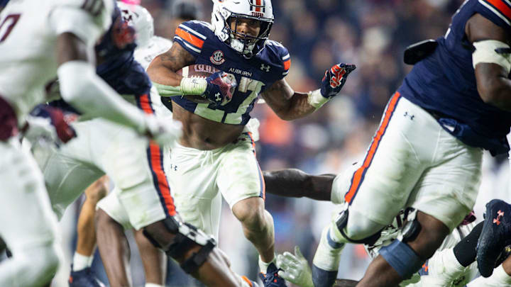 Auburn Tigers running back Jarquez Hunter (27) runs the ball as Auburn Tigers take on Texas A&M Aggies at Jordan-Hare Stadium in Auburn, Ala., on Saturday, Sept. 7, 2024. Auburn Tigers defeated Texas A&M Aggies 43-41 in fourth overtime.