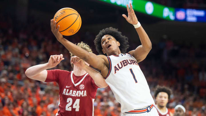 Auburn Tigers guard Aden Holloway (1) goes up for a layup as Auburn Tigers take on Alabama Crimson Auburn Tigers guard Aden Holloway (1) goes up for a layup as Auburn Tigers take on Alabama Crimson