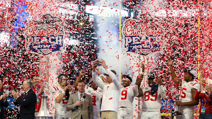 Dec 30, 2023; Atlanta, GA, USA; Mississippi Rebels head coach Lane Kiffin holds up the Peach Bowl Trophy Dec 30, 2023; Atlanta, GA, USA; Mississippi Rebels head coach Lane Kiffin holds up the Peach Bowl Trophy