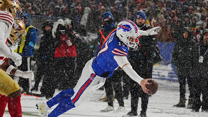 Allen leaps to the end zone on a nine-yard touchdown run after getting the ball passed back to him from Amari Cooper during a game against the 49ers. 