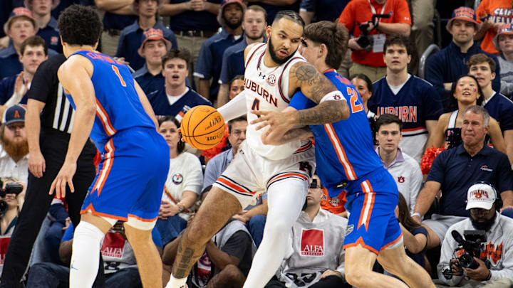 Auburn Tigers forward Johni Broome (4) makes a post move on Florida Gators center Alex Condon (21) as Auburn Tigers take on Florida Gators at Neville Arena in Auburn, Ala., on Saturday, Feb. 8, 2025.