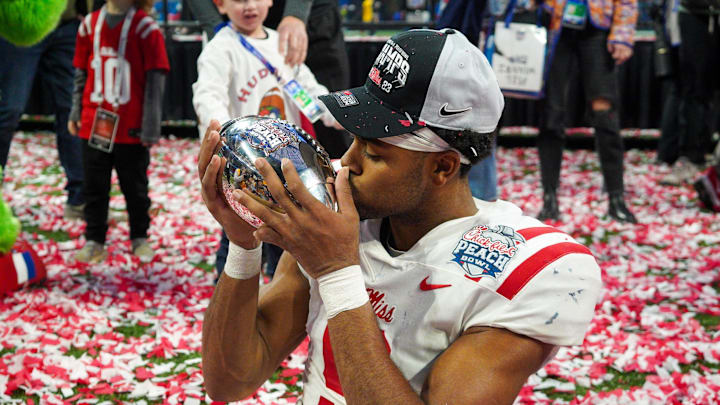 Dec 30, 2023; Atlanta, GA, USA; Mississippi Rebels wide receiver Tre Harris (9) celebrates with the trophy after a victory against the Penn State Nittany Lions in the Peach Bowl at Mercedes-Benz Stadium. Mandatory Credit: Brett Davis-Imagn Images
