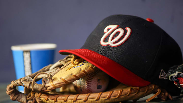 Sep 29, 2023; Atlanta, Georgia, USA; A detailed view of a Washington Nationals hat and glove on the bench against the Atlanta Braves in the third inning at Truist Park. Sep 29, 2023; Atlanta, Georgia, USA; A detailed view of a Washington Nationals hat and glove on the bench against the Atlanta Braves in the third inning at Truist Park.