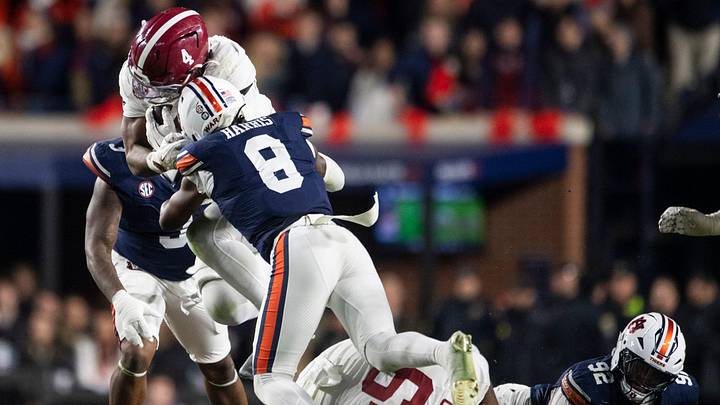 Alabama Crimson Tide running back Daniel Hill (4) is tackled by Auburn Tigers safety Kaleb Harris (8) as Auburn Tigers take on Alabama Crimson Tide in the Iron Bowl at Jordan-Hare Stadium in Auburn, Ala. on Saturday, Nov. 29, 2025. Alabama Crimson Tide defeated Auburn Tigers 27-20. Alabama Crimson Tide running back Daniel Hill (4) is tackled by Auburn Tigers safety Kaleb Harris (8) as Auburn Tigers take on Alabama Crimson Tide in the Iron Bowl at Jordan-Hare Stadium in Auburn, Ala. on Saturday, Nov. 29, 2025. Alabama Crimson Tide defeated Auburn Tigers 27-20.