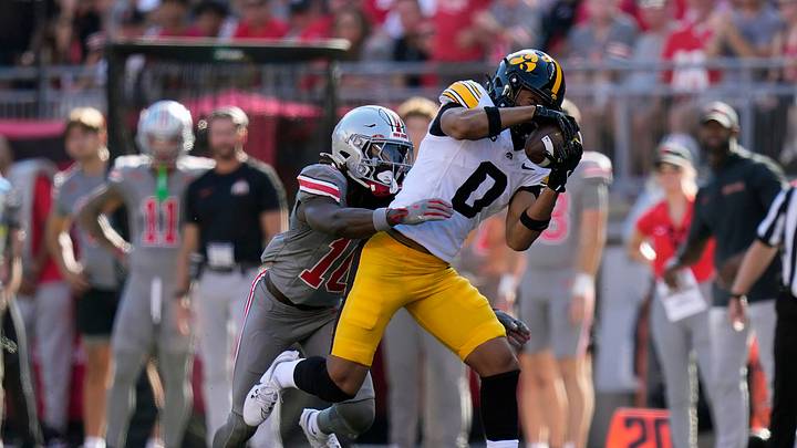 Oct 5, 2024; Columbus, OH, USA; Iowa Hawkeyes wide receiver Jarriett Buie (0) makes a catch against Ohio State Buckeyes cornerback Denzel Burke (10) in the second quarter during the NCAA football game at Ohio Stadium. Oct 5, 2024; Columbus, OH, USA; Iowa Hawkeyes wide receiver Jarriett Buie (0) makes a catch against Ohio State Buckeyes cornerback Denzel Burke (10) in the second quarter during the NCAA football game at Ohio Stadium.