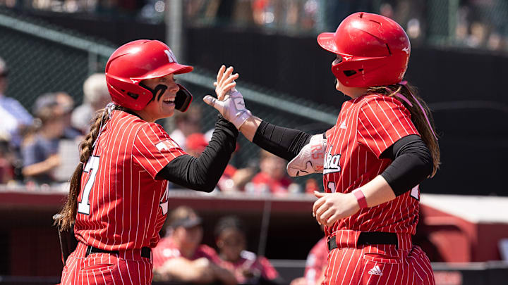 Nebraska shortstop Ava Kuszak (left) and utility Olivia DiNardo celebrate during the Huskers' 9-2 win Saturday over Maryland in front of a sold-out Bowlin Stadium.