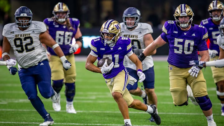 Dezmen Roebuck (81) gets loose on a fly sweep, escorted by Carver Willis (50), to score on a 47-yard touchdown play against UC Davis. 