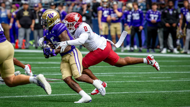 Buddah Al-Uqdah tackles Giles Jackson in the 2024 Apple Cup for WSU.