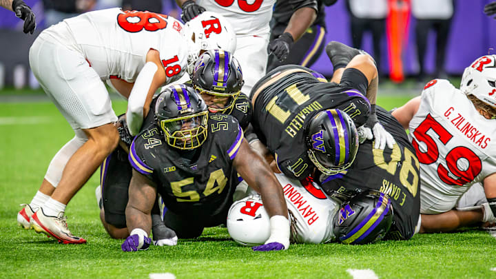 Anterio Thompson (54), Ta'ita'i Uiagalelei (11) and Elinneus Davis (90) bring down Rutgers' Antwan Raymond. Anterio Thompson (54), Ta'ita'i Uiagalelei (11) and Elinneus Davis (90) bring down Rutgers' Antwan Raymond.