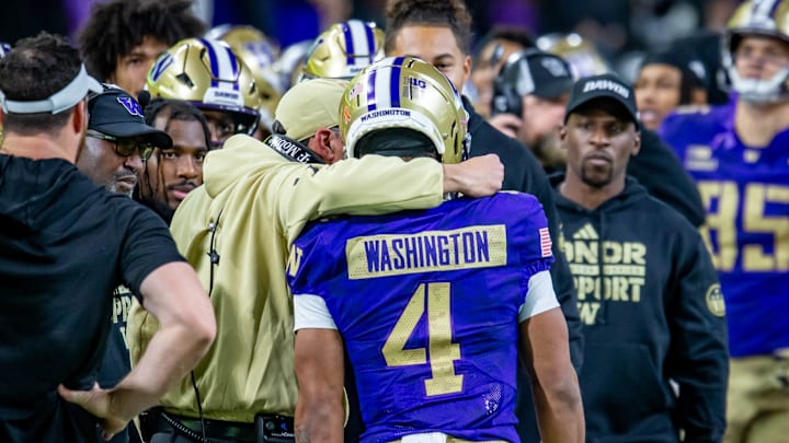 Jedd Fisch and running back Jordan Washington confer on the sideline. Jedd Fisch and running back Jordan Washington confer on the sideline.