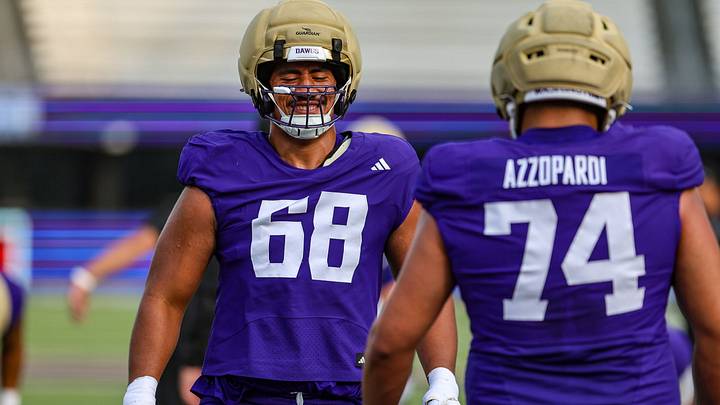 Soane Faasolo passes Drew Azzopardi in an offensive-line drill. 