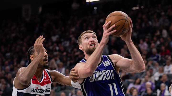 Jan 19, 2025; Sacramento, California, USA; Sacramento Kings forward Domantas Sabonis (11) drives to the basket against Washington Wizards forward Alexandre Sarr (20) during the third quarter at Golden 1 Center. Mandatory Credit: Ed Szczepanski-Imagn Images