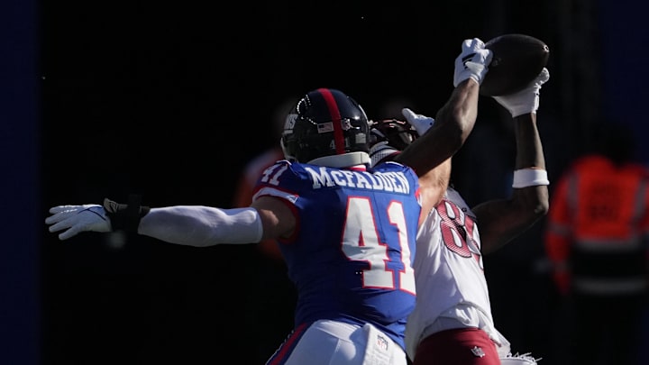 Nov 3, 2024; East Rutherford, New Jersey, USA; Washington Commanders wide receiver Noah Brown (85) hauls in a pass in front of New York Giants linebacker Micah McFadden (41) during the first half at MetLife Stadium. Mandatory Credit: Robert Deutsch-Imagn Images