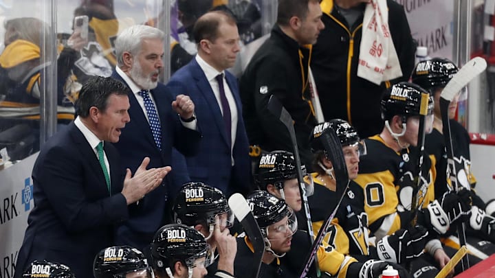 Mar 16, 2024; Pittsburgh, Pennsylvania, USA; Pittsburgh Penguins head coach Mike Sullivan (rear left) reacts on he bench against the New York Rangers during the third period at PPG Paints Arena. New York won 7-4.  Mandatory Credit: Charles LeClaire-Imagn Images