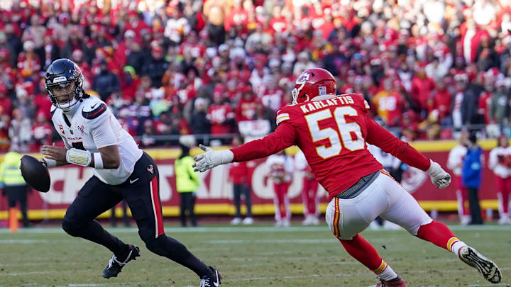 Dec 21, 2024; Kansas City, Missouri, USA; Houston Texans quarterback C.J. Stroud (7) scrambles in the backfield as Kansas City Chiefs defensive end George Karlaftis (56) defends during the second half at GEHA Field at Arrowhead Stadium. Mandatory Credit: Denny Medley-Imagn Images