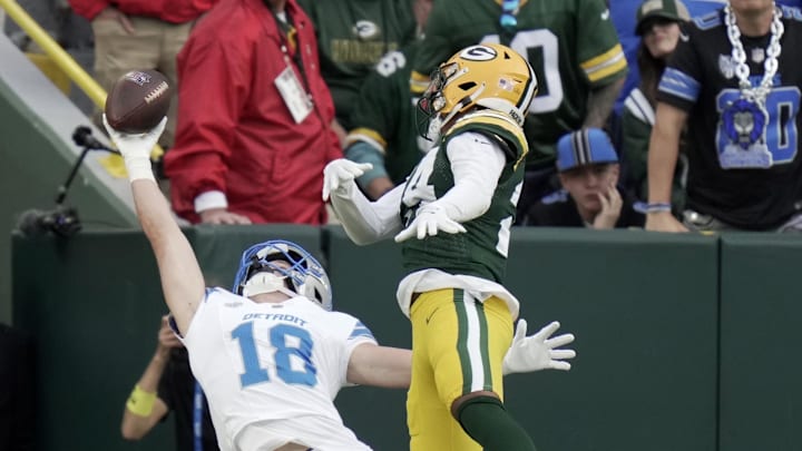 Sep 7, 2025; Green Bay, Wisconsin, USA; Detroit Lions wide receiver Isaac TeSlaa (18) catches a touchdown pass while being covered by Green Bay Packers cornerback Carrington Valentine (24) during the fourth quarter at Lambeau Field. The play was originally ruled incomplete but the call was overturned Mandatory Credit: Mark Hoffman-USA TODAY Network via Imagn Images