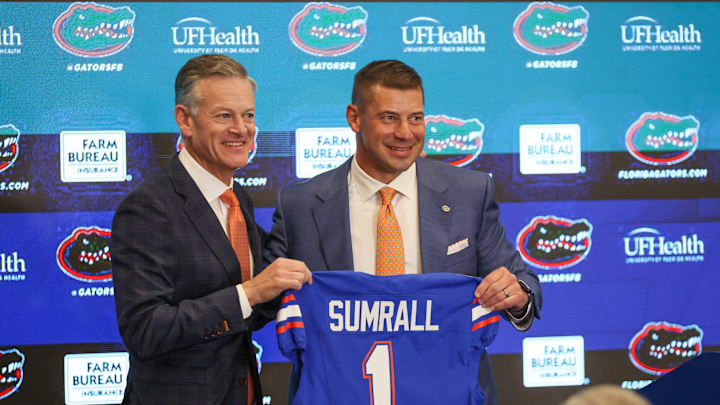 UF Athletic Director Scott Stricklin and new UF head football coach Jon Sumrall pose with a jersey at a press conference James W. “Bill” Heavener Football Training Center in Gainesville, FL on Monday, December 1, 2025. [Alan Youngblood/Gainesville Sun]
