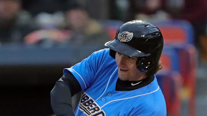 Akron RubberDucks centerfielder Chase DeLauter (22) connects with a pitch during the first inning of an opening-day baseball game at Canal Park, Friday, April 5, 2024, in Akron, Ohio.