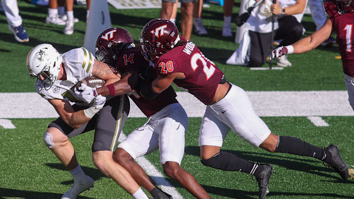 Oct 11, 2025; Atlanta, Ga.; Georgia Tech tight end Josh Beetham (17) is tackled by Virginia Tech safety Sheldon Robinson (14) and linebacker Caleb Woodson (20).