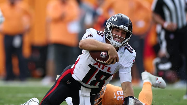 Oct 27, 2024; Tampa, Florida, USA; Atlanta Falcons quarterback Kirk Cousins (18) is brought down by Tampa Bay Buccaneers safety Josh Hayes (32) in the fourth quarter at Raymond James Stadium. Mandatory Credit: Nathan Ray Seebeck-Imagn Images