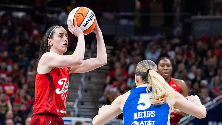 Aug 14, 2026; Indianapolis, Indiana, USA;  Indiana Fever guard Caitlin Clark (22) shoots the ball while Dallas Wings guard Paige Bueckers (5) defends in the first half at Gainbridge Fieldhouse. Mandatory Credit: Trevor Ruszkowski-Imagn Images