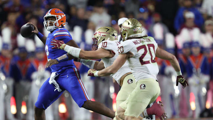 Florida quarterback DJ Lagway (2) throws Florida quarterback DJ Lagway (2) gets pressure from Florida State defensive lineman James Williams (10) during the first half of an NCAA football game at Steve Spurrier Field at Ben Hill Griffin Stadium in Gainesville, FL on Saturday, November 29, 2025. [Alan Youngblood/Gainesville Sun]
