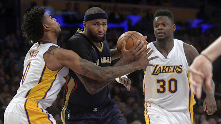 March 5, 2017; Los Angeles, CA, USA; New Orleans Pelicans forward DeMarcus Cousins (0) moves to the basket against Los Angeles Lakers guard Nick Young (0) and forward Julius Randle (30) during the first half at Staples Center. Mandatory Credit: Gary A. Vasquez-Imagn Images