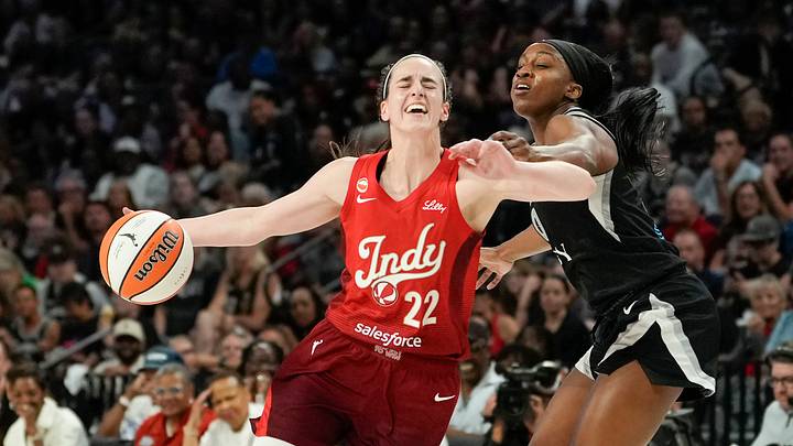 Oct 1, 2026; Las Vegas, Nevada, USA; Indiana Fever guard Caitlin Clark (22) drives the ball against Las Vegas Aces guard Jackie Young (0) during the second quarter of game three of the first round for the 2026 WNBA Playoffs at Michelob Ultra Arena. Mandatory Credit: Lucas Peltier-Imagn Images Oct 1, 2026; Las Vegas, Nevada, USA; Indiana Fever guard Caitlin Clark (22) drives the ball against Las Vegas Aces guard Jackie Young (0) during the second quarter of game three of the first round for the 2026 WNBA Playoffs at Michelob Ultra Arena. Mandatory Credit: Lucas Peltier-Imagn Images