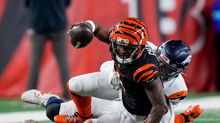 Cincinnati Bengals wide receiver Ja'Marr Chase (1) stretches as he comes down with a catch in the fourth quarter of the NFL Week 17 game between the Cincinnati Bengals and the Denver Broncos at Paycor Stadium in downtown Cincinnati on Saturday, Dec. 28, 2024. The Bengals took a 30-24 win in overtime to remain in the post season chase.