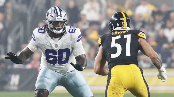 Oct 6, 2024; Pittsburgh, Pennsylvania, USA;  Dallas Cowboys offensive tackle Tyler Guyton (60) blocks at the line of scrimmage against Pittsburgh Steelers linebacker Nick Herbig (51) during the first quarter at Acrisure Stadium. Mandatory Credit: Charles LeClaire-Imagn Images