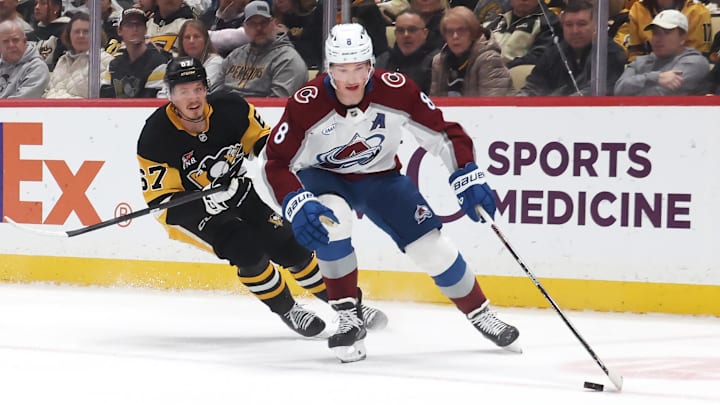 Mar 24, 2026; Pittsburgh, Pennsylvania, USA;  Colorado Avalanche defenseman Cale Makar (8) moves the puck a=head of Pittsburgh Penguins right wing Rickard Rakell (67) during the first period at PPG Paints Arena. Mandatory Credit: Charles LeClaire-Imagn Images