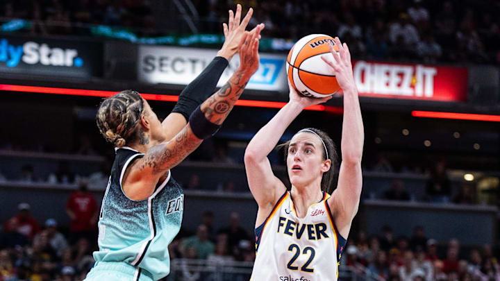 May 24, 2025; Indianapolis, Indiana, USA; Indiana Fever guard Caitlin Clark (22) shoots the ball while New York Liberty guard Natasha Cloud (9)  defends in the second half at Gainbridge Fieldhouse. Mandatory Credit: Trevor Ruszkowski-Imagn Images