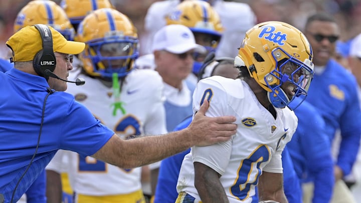 Oct 11, 2025; Tallahassee, Florida, USA; Pittsburgh Panthers running back Desmond Reid (0) is held back as he reacts to a big play in the first quarter against the Florida State Seminoles at Doak S. Campbell Stadium. Mandatory Credit: Melina Myers-Imagn Images Oct 11, 2025; Tallahassee, Florida, USA; Pittsburgh Panthers running back Desmond Reid (0) is held back as he reacts to a big play in the first quarter against the Florida State Seminoles at Doak S. Campbell Stadium. Mandatory Credit: Melina Myers-Imagn Images