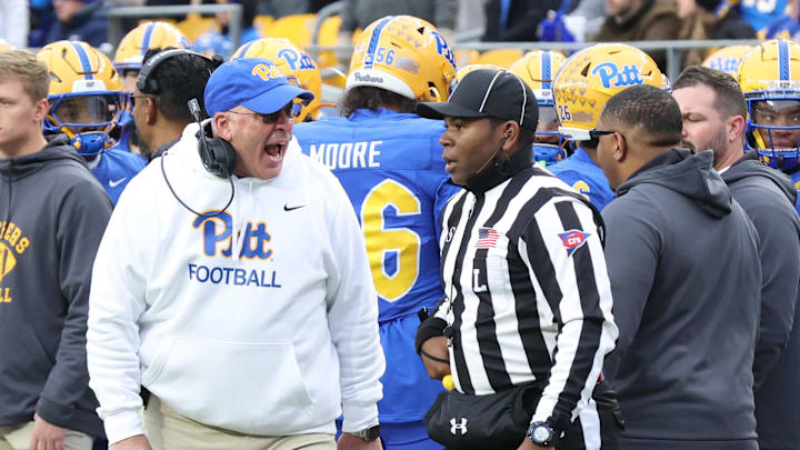 Nov 29, 2025; Pittsburgh, Pennsylvania, USA;  Pittsburgh Panthers head coach Pat Narduzzi (left) reacts to line judge Josiah Ford (right) during the third quarter against the Miami Hurricanes at Acrisure Stadium. Mandatory Credit: Charles LeClaire-Imagn Images