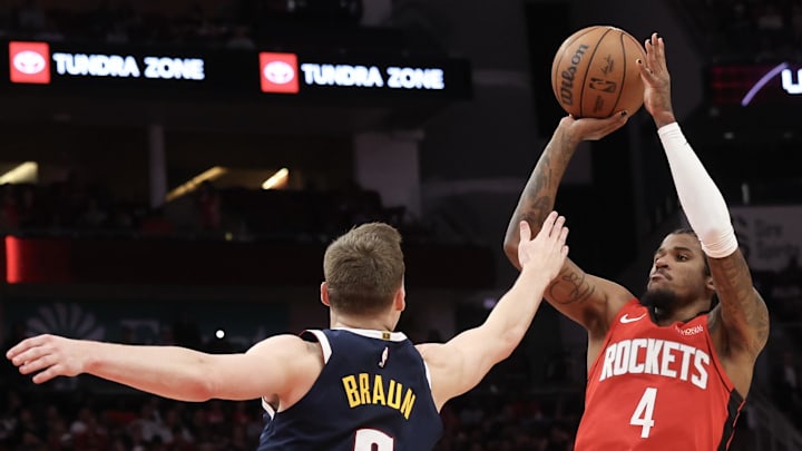 Houston Rockets guard Jalen Green shoots against Denver Nuggets guard Christian Braun.
