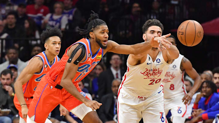 Jan 12, 2023; Philadelphia, Pennsylvania, USA; Oklahoma City Thunder guard Isaiah Joe (11) and Philadelphia 76ers forward Georges Niang (20) battle for the ball during the third quarter at Wells Fargo Center. Mandatory Credit: Eric Hartline-Imagn Images