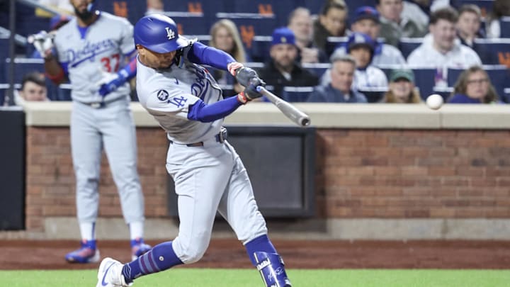 May 24, 2025; New York City, New York, USA;  Los Angeles Dodgers shortstop Mookie Betts (50) hits a single in the sixth inning against the New York Mets at Citi Field. Mandatory Credit: Wendell Cruz-Imagn Images
