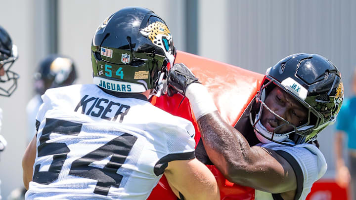 Jacksonville Jaguars linebacker Jack Kiser (54) uses a blocking pad as Jacksonville Jaguars Devin Lloyd (0) drives through him during the fourth organized team activity at the Miller Electric Center in Jacksonville, Fla. Tuesday, May 27, 2025. [Doug Engle/Florida Times-Union]