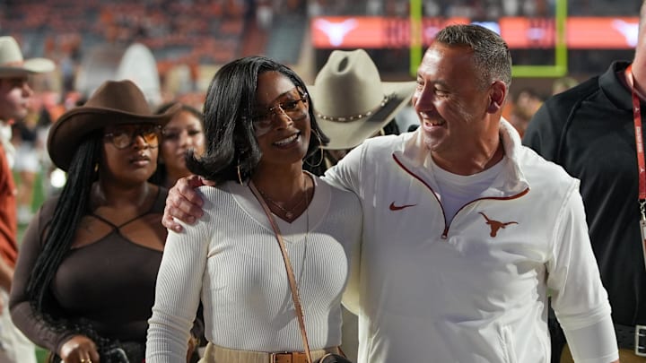 Texas Longhorns head coach Steve Sarkisian and his wife Loreal Sarkisian walk off the field after defeating the Kentucky Wildcats at Darrell K Royal Texas Memorial Stadium.