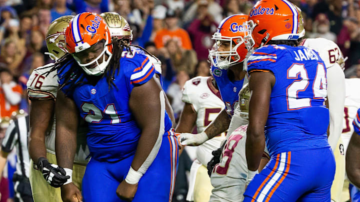 Florida Gators defensive lineman Desmond Watson (21) celebrates his sack of Florida State Seminoles quarterback Tate Rodemaker (18) at Steve Spurrier Field at Ben Hill Griffin Stadium in Gainesville, FL on Saturday, November 25, 2023 during the second half. Florida State won 24-15. [Doug Engle/Gainesville Sun]