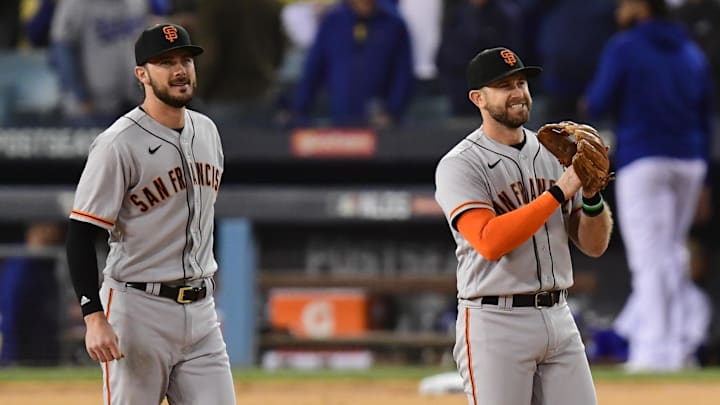 Oct 11, 2021; Los Angeles, California, USA; San Francisco Giants third baseman Evan Longoria (10) and first baseman Kris Bryant (23) celebrate after defeating the Los Angeles Dodgers in game three of the 2021 NLDS at Dodger Stadium. Mandatory Credit: Gary A. Vasquez-Imagn Images