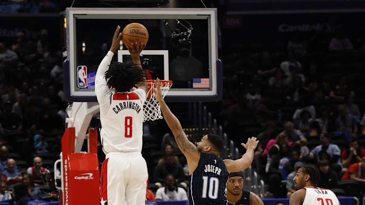 Apr 3, 2025; Washington, District of Columbia, USA; Washington Wizards guard Bub Carrington (8) shoots the ball as Orlando Magic guard Cory Joseph (10) defends in the first half at Capital One Arena. Mandatory Credit: Geoff Burke-Imagn Images