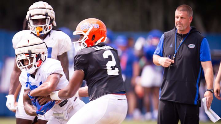 Florida Gators running back KD Daniels (21) tucks the ball after the hand off from Florida Gators quarterback DJ Lagway (2) during Fall practice at Sanders Practice Fields in Gainesville, FL on Tuesday, August 13, 2024. [Doug Engle/Gainesville Sun]