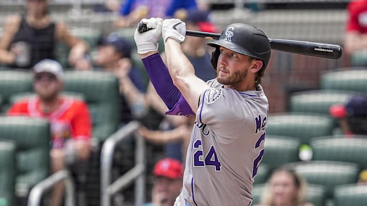 Jun 15, 2025; Cumberland, Georgia, USA; Colorado Rockies third baseman Ryan McMahon (24) hits a home run against the Atlanta Braves during the seventh inning at Truist Park.