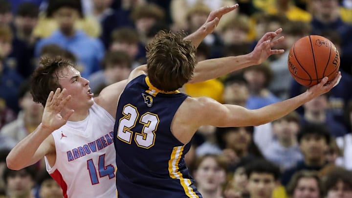 Arrowhead High School's Bennett Basich (14) contests a shot by Marquette University High School's Nolan Minessale (23). 
