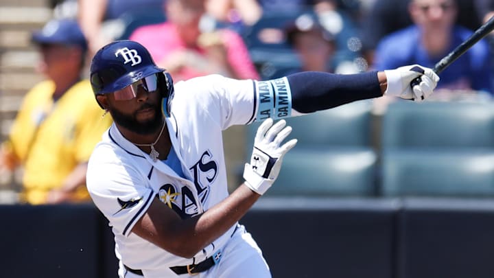 Tampa, Florida, USA; Tampa Bay Rays third baseman Junior Caminero (13) hits a base hit against the Atlanta Braves in the first inning at George M. Steinbrenner Field.