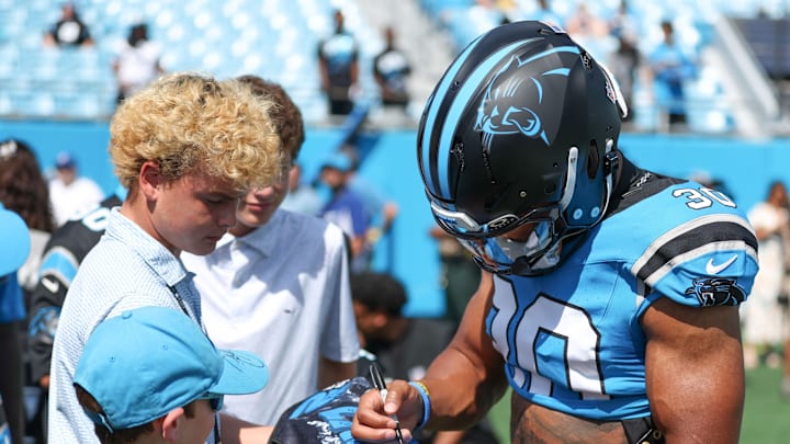 Sep 21, 2025; Charlotte, North Carolina, USA; Carolina Panthers running back Chuba Hubbard (30) signs autographs for fans before a game between Carolina Panthers and the Atlanta Falcons at Bank of America Stadium. Sep 21, 2025; Charlotte, North Carolina, USA; Carolina Panthers running back Chuba Hubbard (30) signs autographs for fans before a game between Carolina Panthers and the Atlanta Falcons at Bank of America Stadium.
