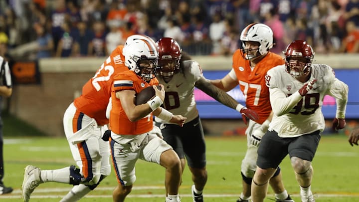Oct 18, 2025; Charlottesville, Virginia, USA; Virginia Cavaliers quarterback Chandler Morris (4) runs with the ball as Washington State Cougars defensive lineman Bryson Lamb (99) chases in the fourth quarter at Scott Stadium. Mandatory Credit: Geoff Burke-Imagn Images