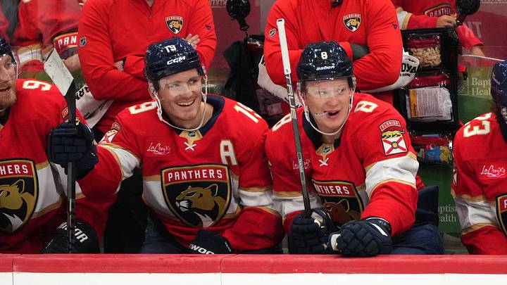 Sep 20, 2026; Sunrise, Florida, USA;  Florida Panthers left wing Matthew Tkachuk (19) and his brother, left wing Brady Tkachuk (8), sit on the bench during the third period against the Carolina Hurricanes at Amerant Bank Arena.  Mandatory Credit: Jim Rassol-Imagn Images