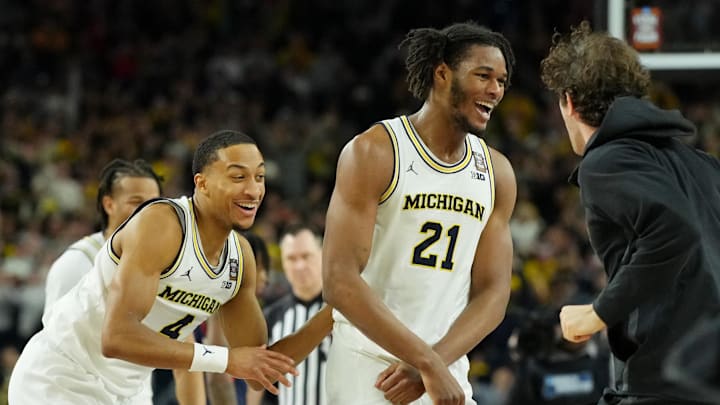Apr 6, 2026; Indianapolis, IN, USA; Michigan Wolverines forward Morez Johnson Jr. (21) and guard Nimari Burnett (4) celebrate after their win against the UConn Huskies in the national championship of the Final Four of the men's 2026 NCAA Tournament between the  and the Michigan Wolverines at Lucas Oil Stadium.